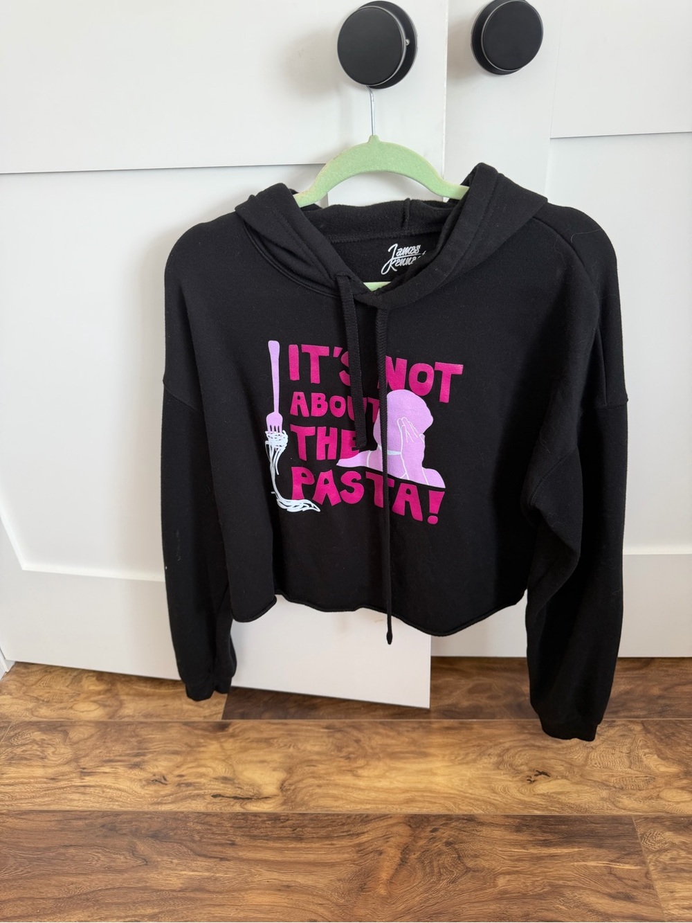 Black Cropped Hoodie with Pink Graphic "It's Not About The Pasta"